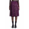 midi-skirt with fringe and grommet embellishment