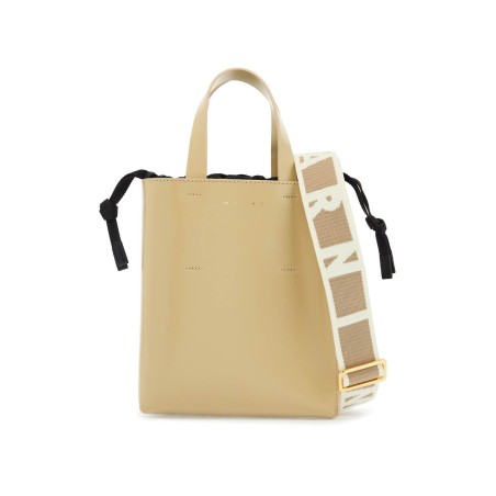 beige leather shopping bag with short handles and shoulder strap