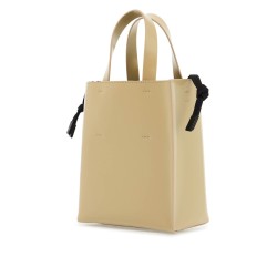 beige leather shopping bag with short handles and shoulder strap