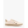 Low-top sneakers realized with foam with lateral openwork