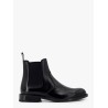Shiny leather boots with engraved logo on the side