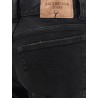 Denim trousers with frayed edges