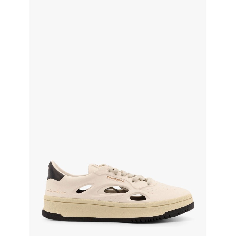 Low-top sneakers realized with foam with lateral openwork