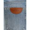 Blue denim jeans with logo label on the back